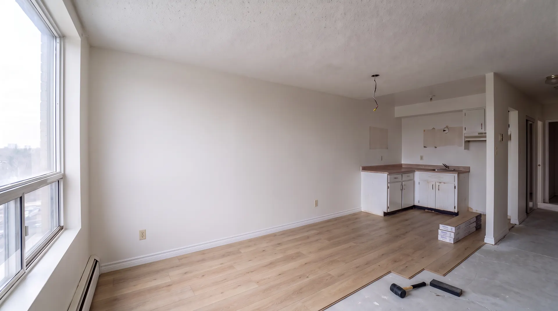 Illustration of the same unit with new oak plank flooring being laid